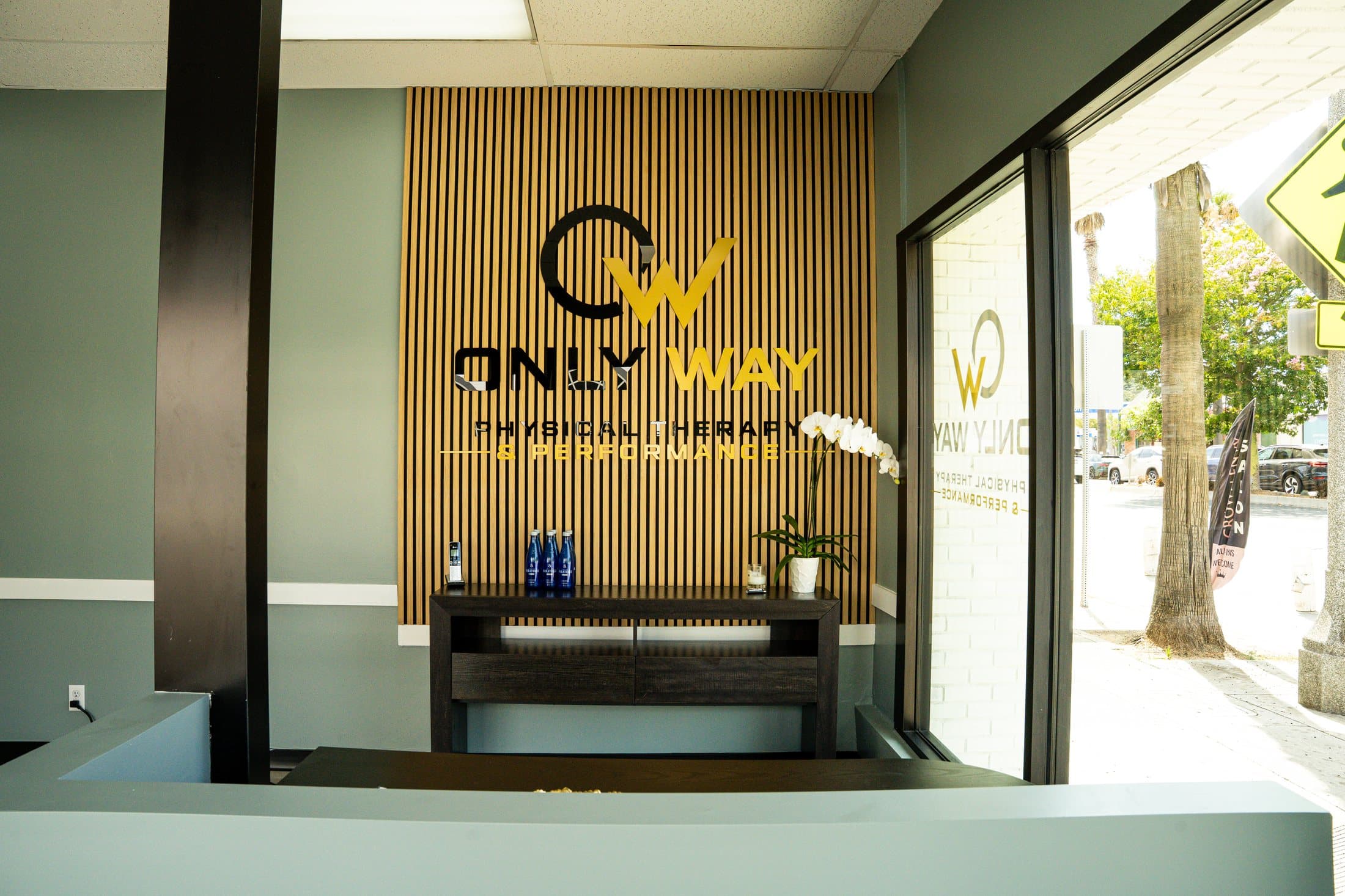 The Only Way PT front desk and branded entry wall